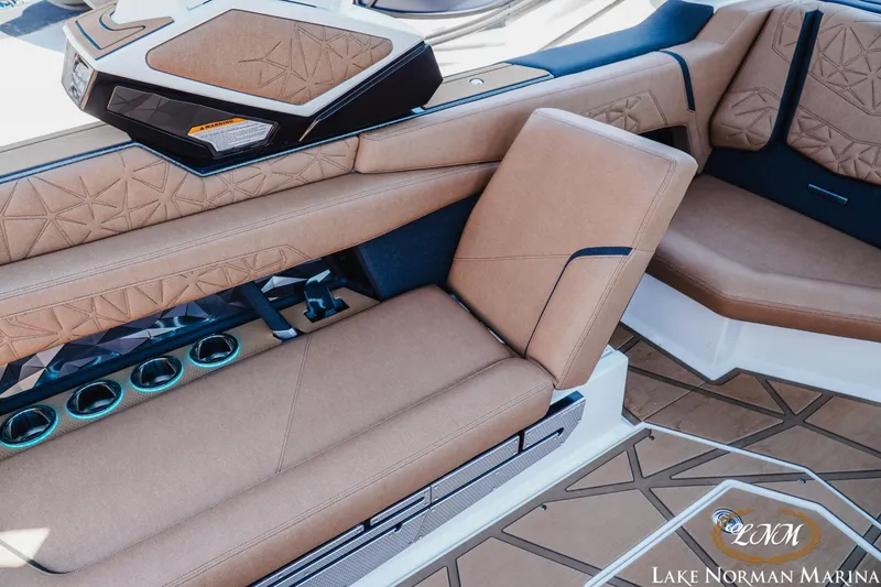 Slide: The Image of 2024 Nautique Super Air Nautique G25 Paragon interior with luxurious tan seating and cup holders. - 36