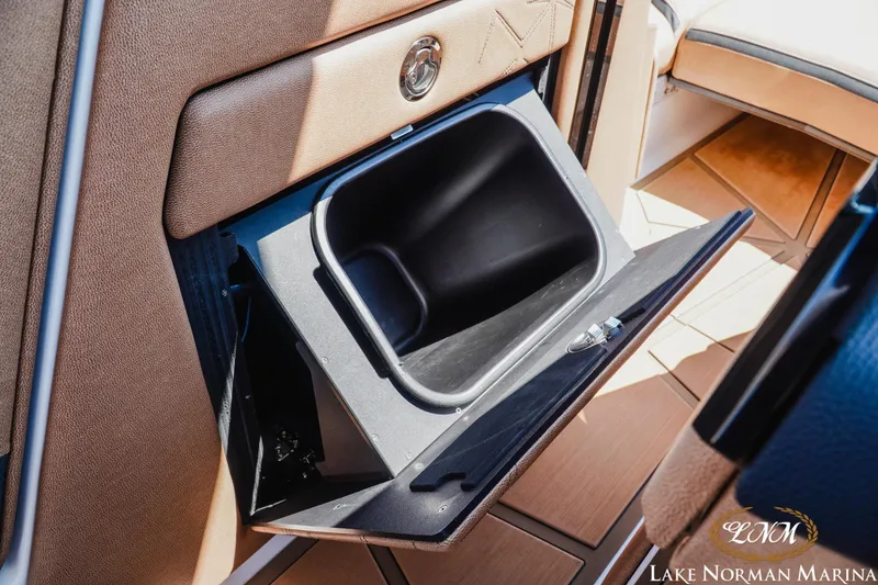 Slide: The Image of 2024 Nautique Super Air Nautique G25 Paragon interior storage compartment, open and empty. - 39