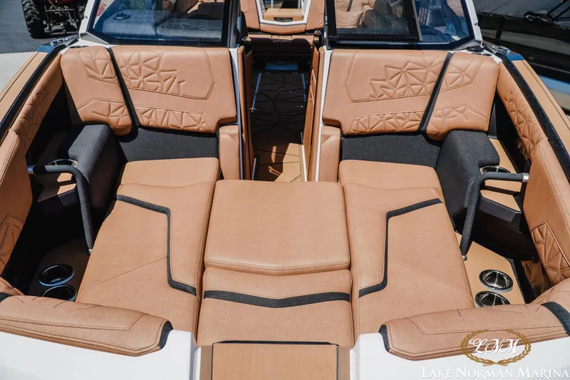 Slide: The Image of 2024 Nautique Super Air Nautique G25 Paragon interior with luxurious tan seating and cup holders. - 9