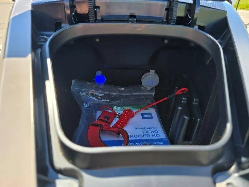 Slide: The Image of Yamaha Waverunner FX HO 2025 storage compartment with accessories and manual. - 24