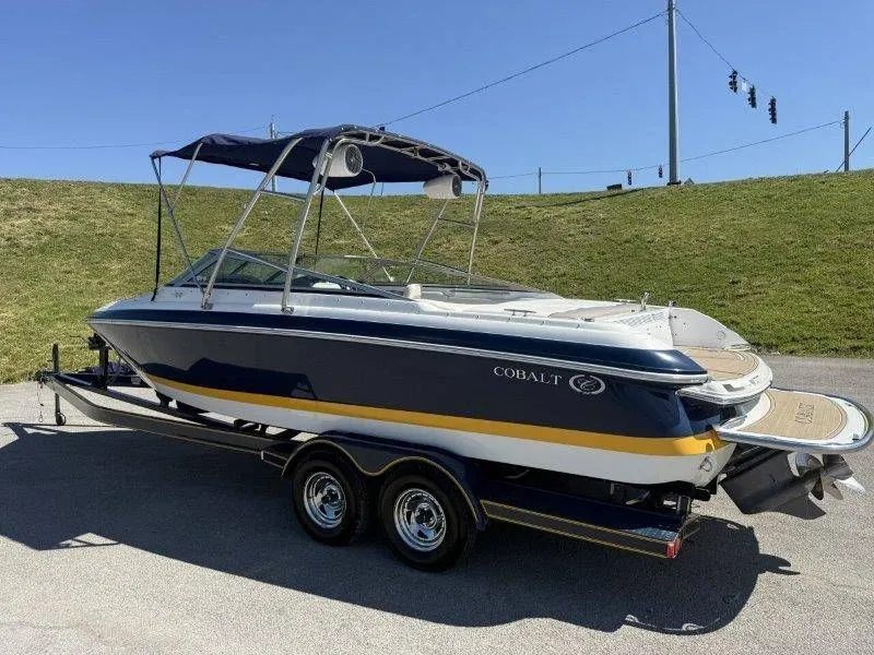 Slide: The Image of 2006 Cobalt 246 boat on trailer, blue and white. - 10