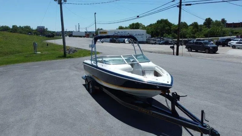 Slide: The Image of 2006 Cobalt 246 boat on trailer in parking lot. - 11