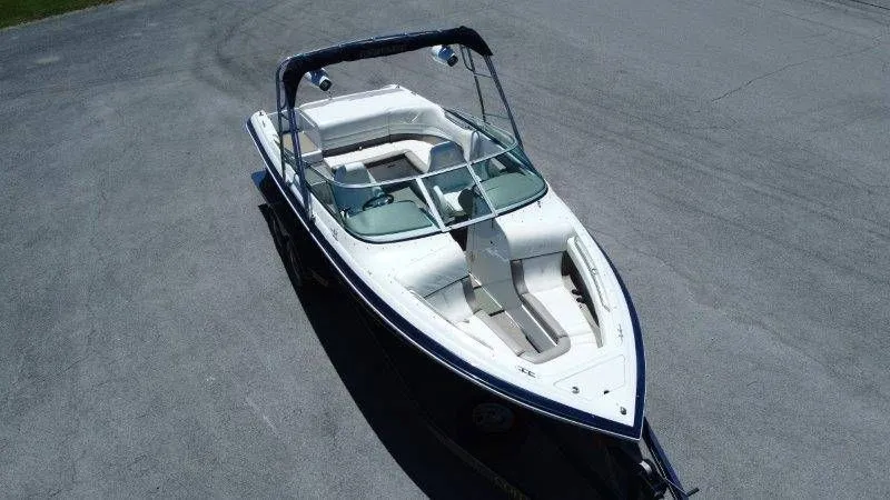Slide: The Image of 2006 Cobalt 246 boat parked on asphalt, aerial view. - 16