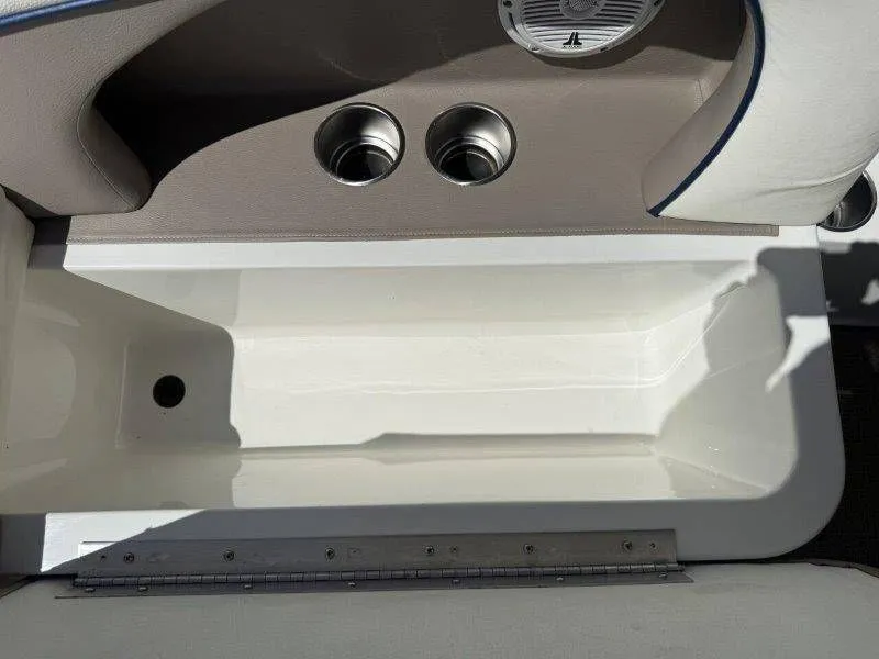 Slide: The Image of Interior of a 2006 Cobalt 246 boat with speaker and cup holders. - 26