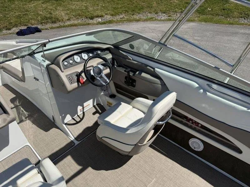 Slide: The Image of Interior of a 2006 Cobalt 246 boat with steering console. - 29