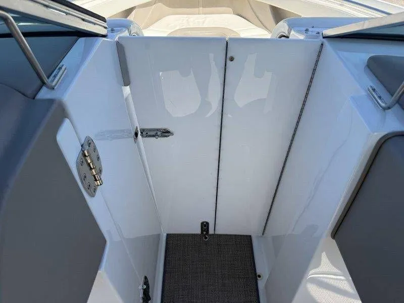 Slide: The Image of Interior of a 2006 Cobalt 246 boat with white interior. - 37