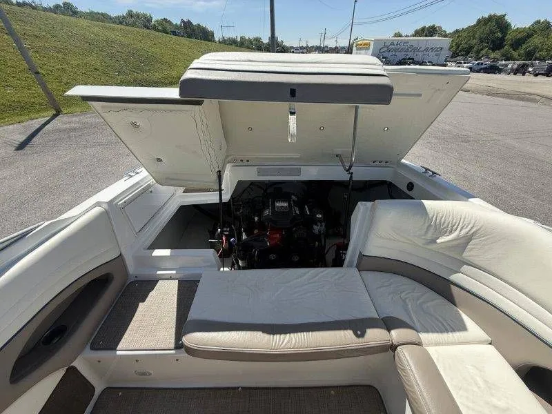 Slide: The Image of 2006 Cobalt 246 boat with open engine compartment and seating area. - 49