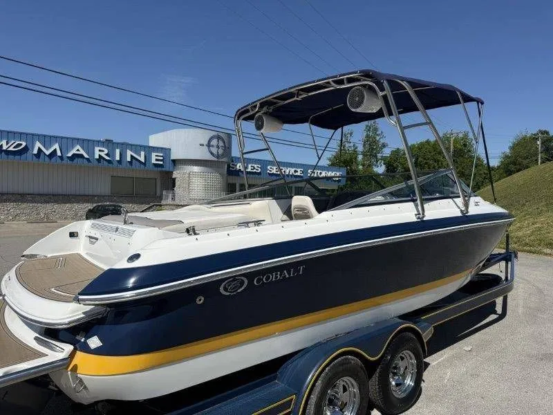 Slide: The Image of 2006 Cobalt 246 boat in front of a marine store. - 8