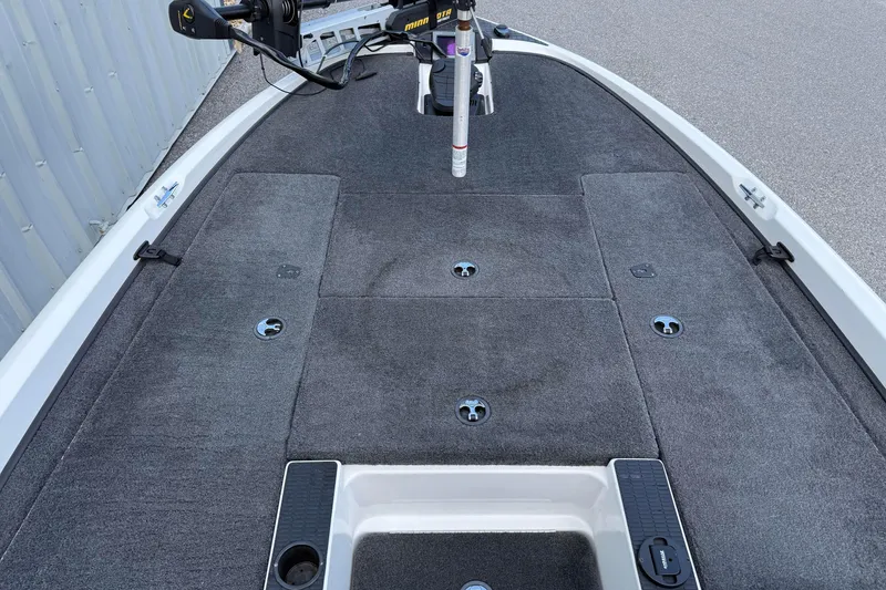 Slide: The Image of 2007 Triton TR-196 boat deck with carpeted surface and mounted trolling motor. - 10