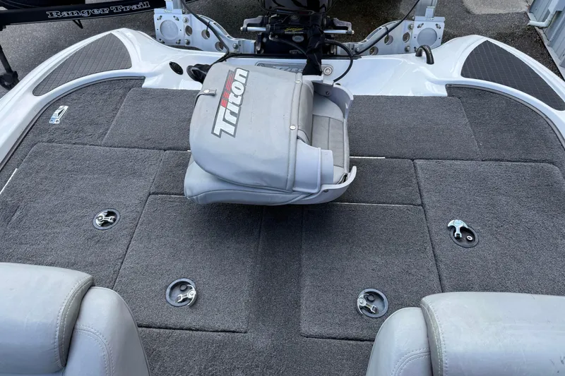Slide: The Image of 2007 Triton TR-196 boat interior with gray carpet and seating. - 11