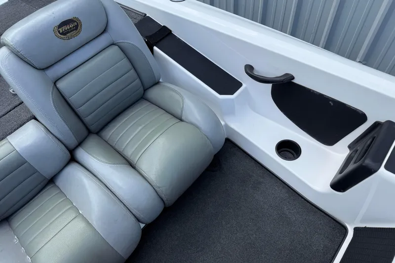 Slide: The Image of 2007 Triton TR-196 boat interior with gray leather seating and cup holder. - 14