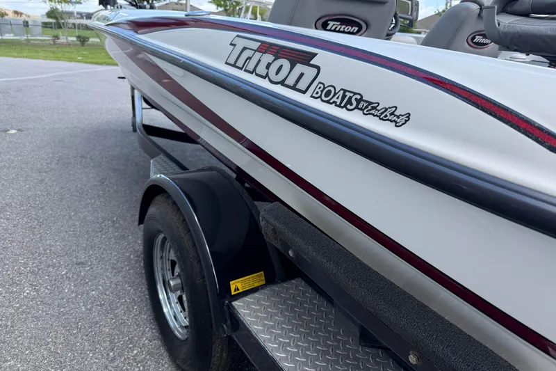 Slide: The Image of 2007 Triton TR-196 boat on trailer, showcasing sleek design and branding details. - 5