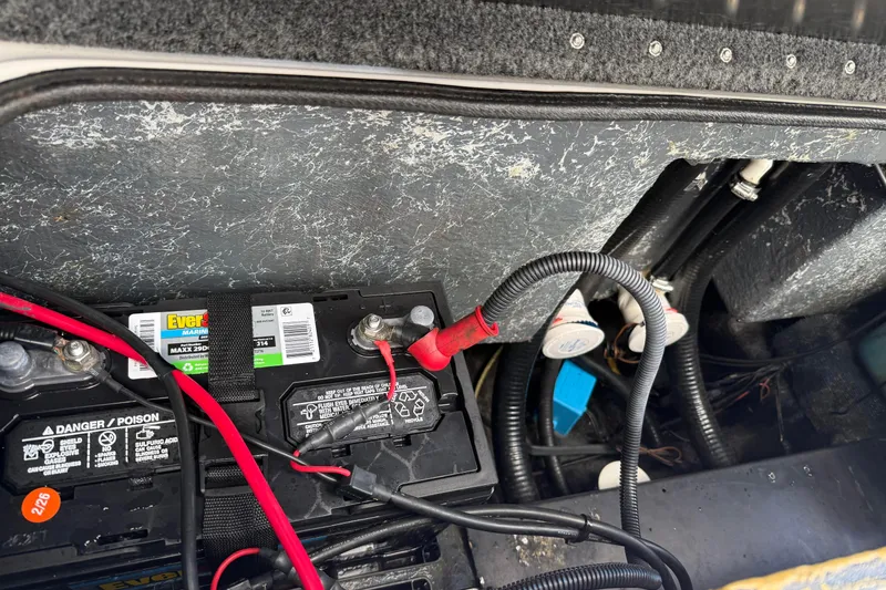 Slide: The Image of 2007 Triton TR-196 boat battery compartment with wiring and connections. - 6