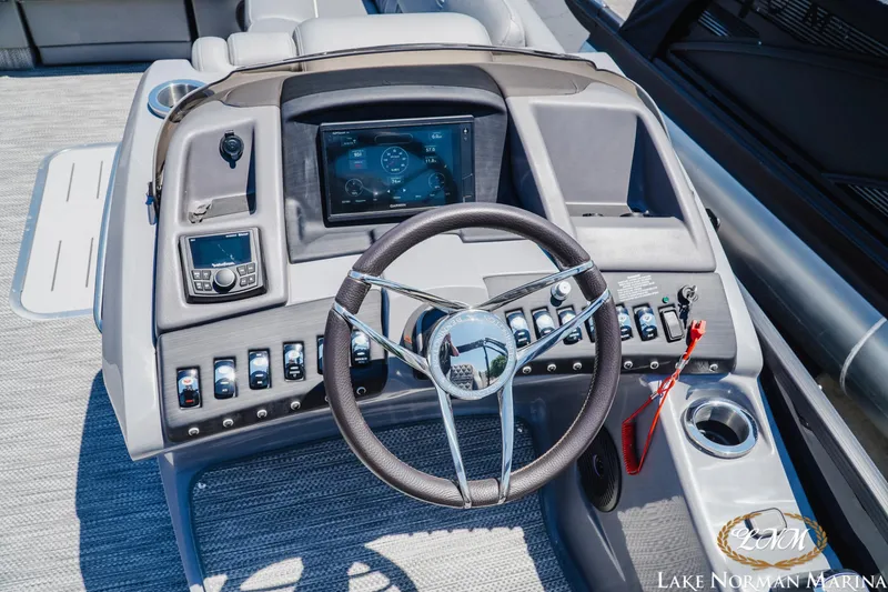 Slide: The Image of 2020 Bennington 25QXSBIO boat dashboard with steering wheel and control panel. - 11