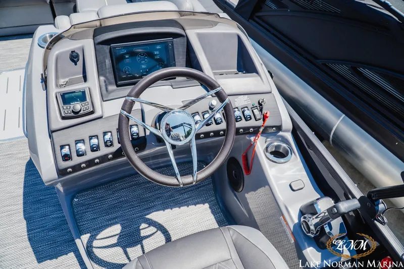 Slide: The Image of 2020 Bennington 25QXSBIO boat dashboard with steering wheel and control panel. - 12