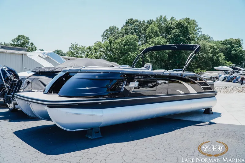 Slide: The Image of 2020 Bennington 25QXSBIO pontoon boat at Lake Norman Marina, sleek black design. - 2
