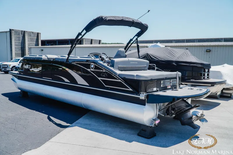 Slide: The Image of 2020 Bennington 25QXSBIO pontoon boat at Lake Norman Marina, featuring sleek black design. - 3
