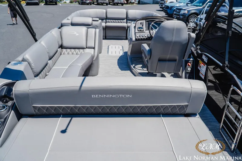 Slide: The Image of 2020 Bennington 25QXSBIO pontoon boat interior with luxurious seating and helm at Lake Norman Marina. - 7