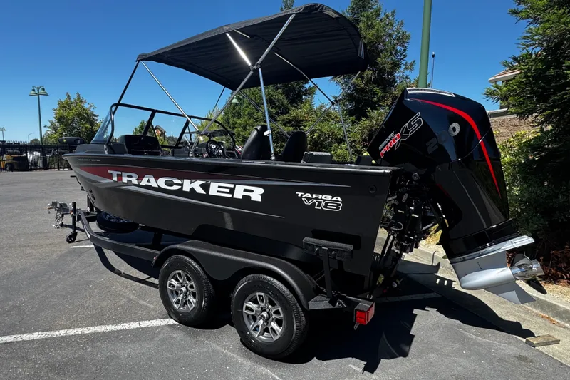 Slide: The Image of 2026 Tracker Targa V-18 Combo boat with powerful engine, parked outdoors on a sunny day. - 76