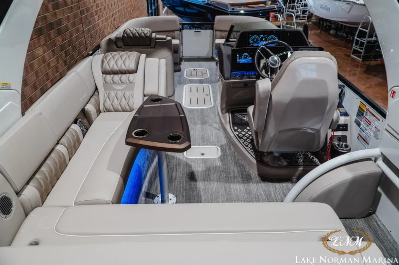 Slide: The Image of Luxurious interior of 2026 Bennington 27QXSBAT2 pontoon boat with plush seating and modern dashboard. - 10