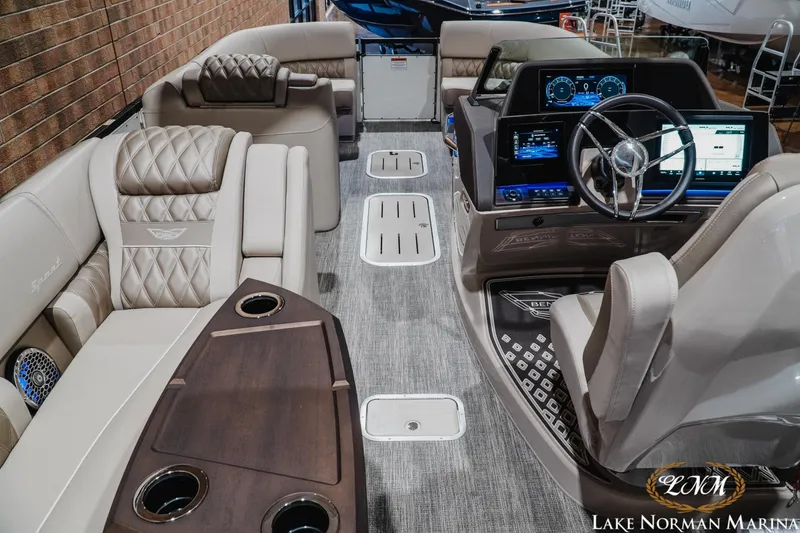 Slide: The Image of Luxurious interior of 2026 Bennington 27QXSBAT2 pontoon boat with plush seating and modern dashboard. - 12