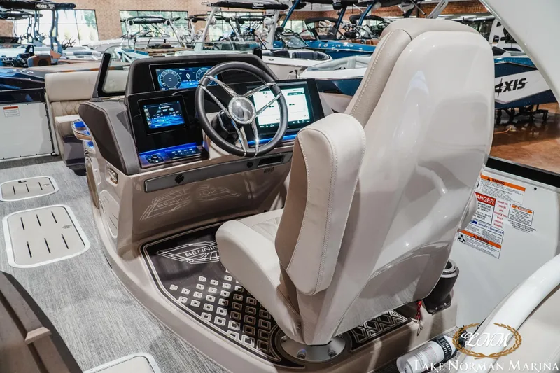 Slide: The Image of 2026 Bennington 27QXSBAT2 boat interior with modern dashboard and steering wheel. - 13