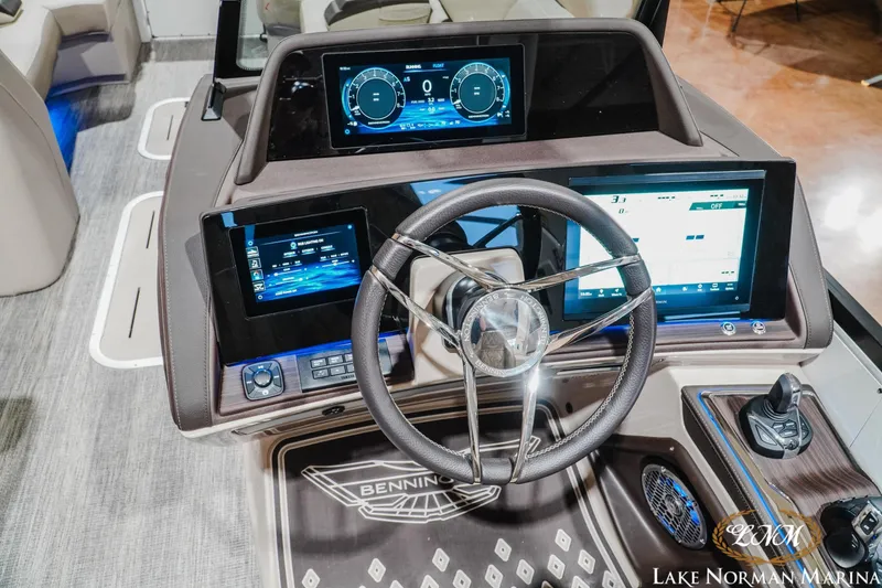 Slide: The Image of 2026 Bennington 27QXSBAT2 boat dashboard with advanced digital displays and steering wheel. - 16