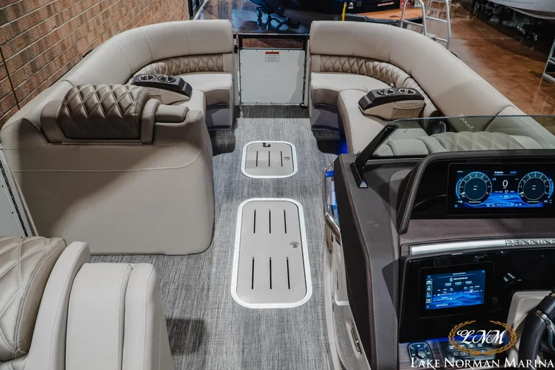 Slide: The Image of Luxurious interior of 2026 Bennington 27QXSBAT2 pontoon boat with plush seating and modern dashboard. - 17