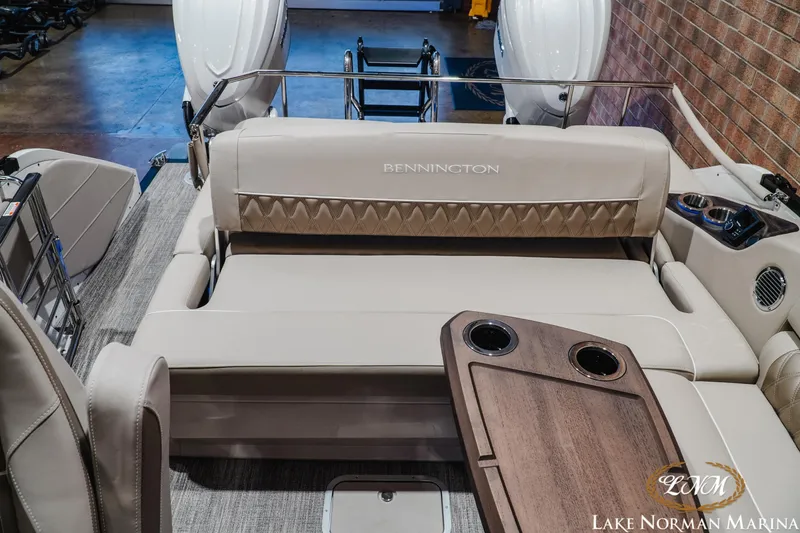Slide: The Image of 2026 Bennington 27QXSBAT2 boat interior with luxurious seating and cup holders at Lake Norman Marina. - 25