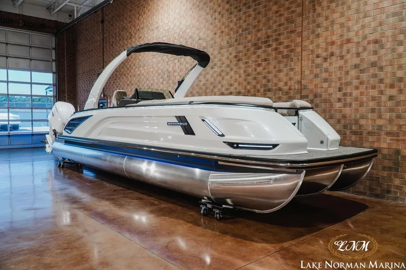 Slide: The Image of 2026 Bennington 27QXSBAT2 pontoon boat displayed indoors at Lake Norman Marina. - 3