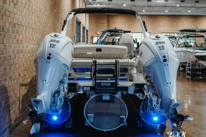 Slide: The Image of 2026 Bennington 27QXSBAT2 boat with dual 350 V6 engines in showroom. - 6