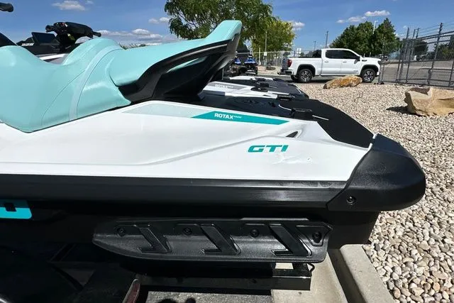 Slide: The Image of 2026 Sea-Doo PWC GTI 130 WH IBR parked in sunlight. - 11
