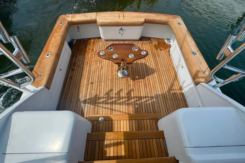 Slide: The Image of Teak deck of 2006 Miller Marine 36 boat with fishing rod holders. - 10