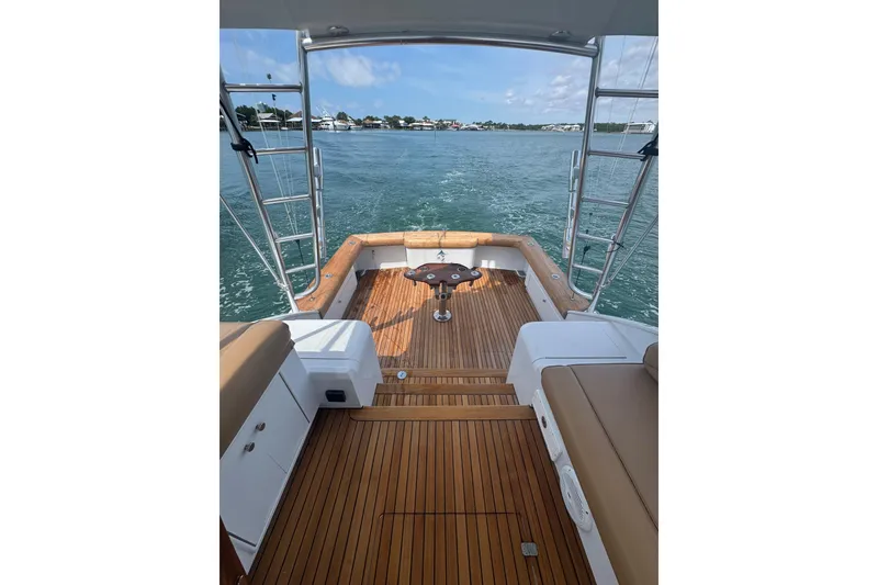 Slide: The Image of 2006 Miller Marine 36 boat deck with wooden flooring and ocean view. - 11