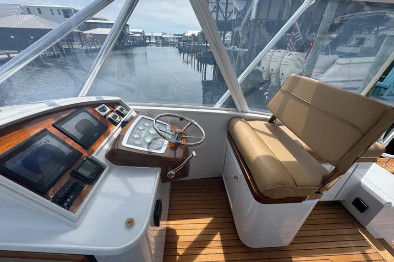 Slide: The Image of Helm of 2006 Miller Marine 36 boat with steering wheel and navigation instruments. - 16
