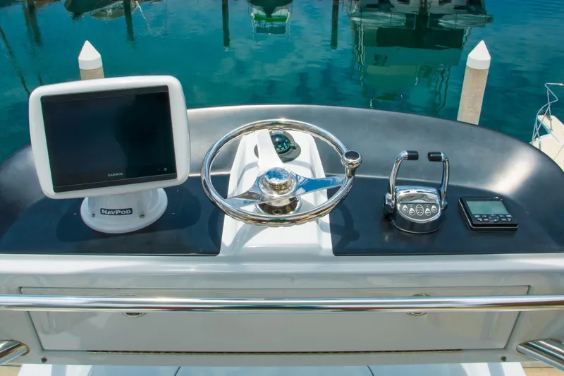 Slide: The Image of Helm of 2006 Miller Marine 36 boat with steering wheel and navigation equipment. - 18