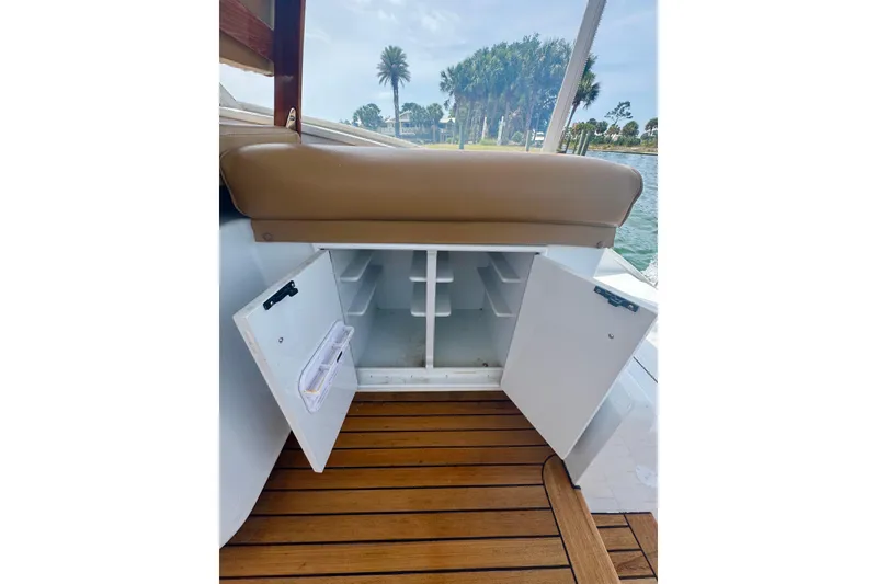 Slide: The Image of Open storage compartment on 2006 Miller Marine 36 boat with wooden deck and scenic view. - 20
