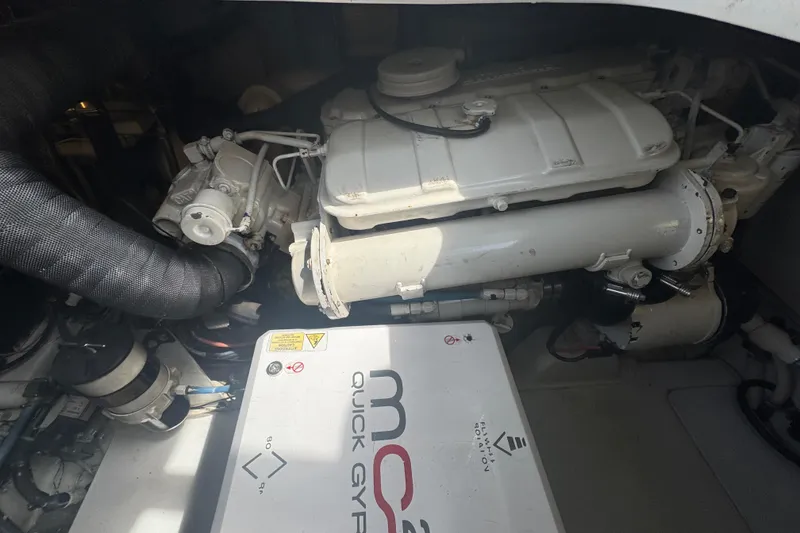 Slide: The Image of Engine compartment of a 2006 Miller Marine 36 boat, featuring mechanical components. - 22