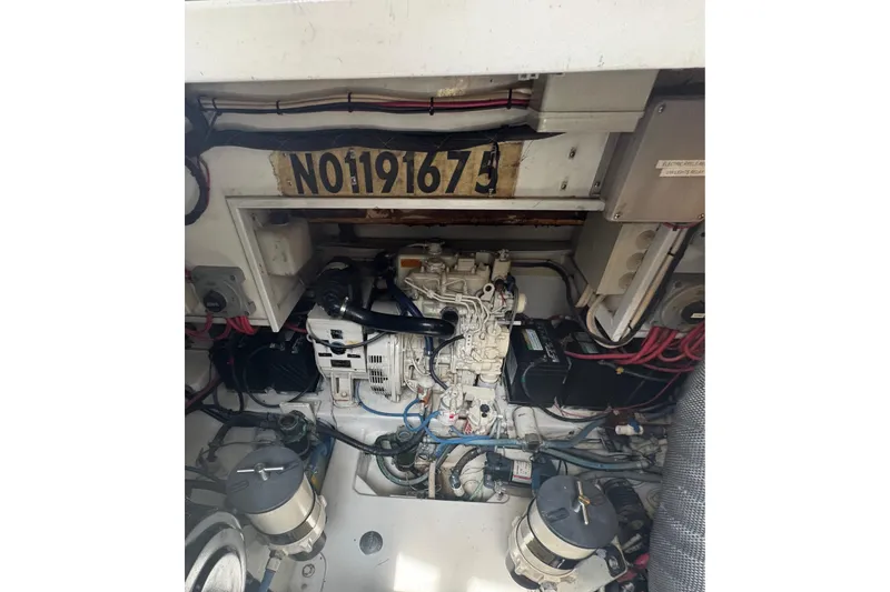 Slide: The Image of Engine compartment of a 2006 Miller Marine 36 boat, showing mechanical components and wiring. - 23