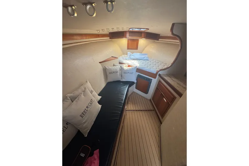 Slide: The Image of Interior of 2006 Miller Marine 36 boat with cozy cabin and wooden accents. - 24