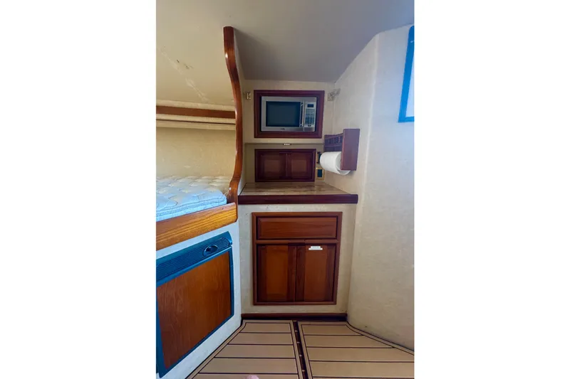Slide: The Image of Interior of 2006 Miller Marine 36 boat with wood cabinetry and built-in microwave. - 25