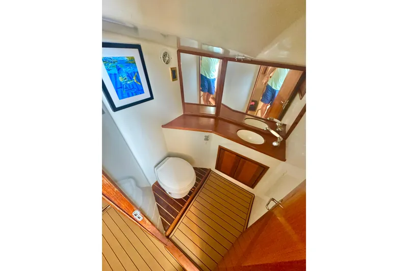 Slide: The Image of Bathroom interior of 2006 Miller Marine 36 yacht with wooden accents and artwork. - 26