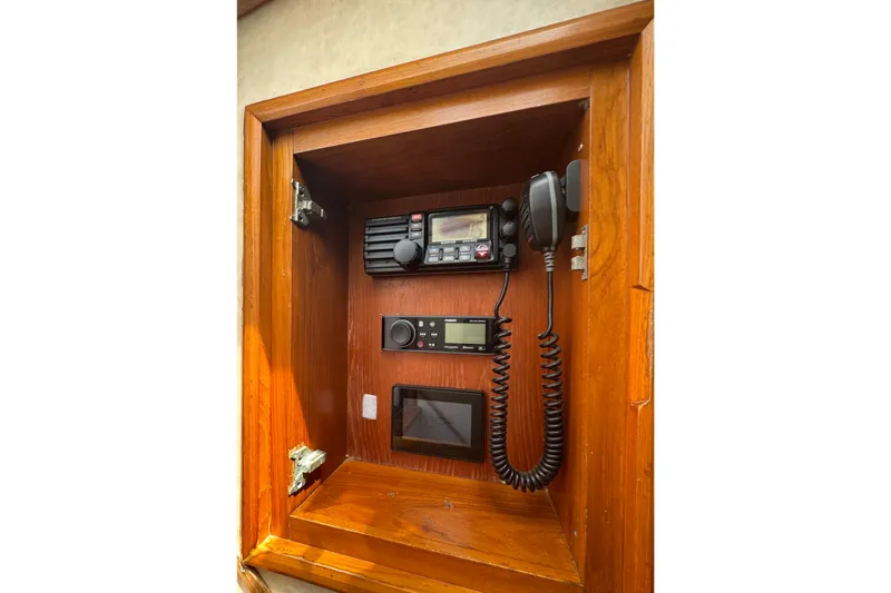 Slide: The Image of Wooden cabinet with marine radio equipment, featuring a 2006 Miller Marine 36 model. - 28