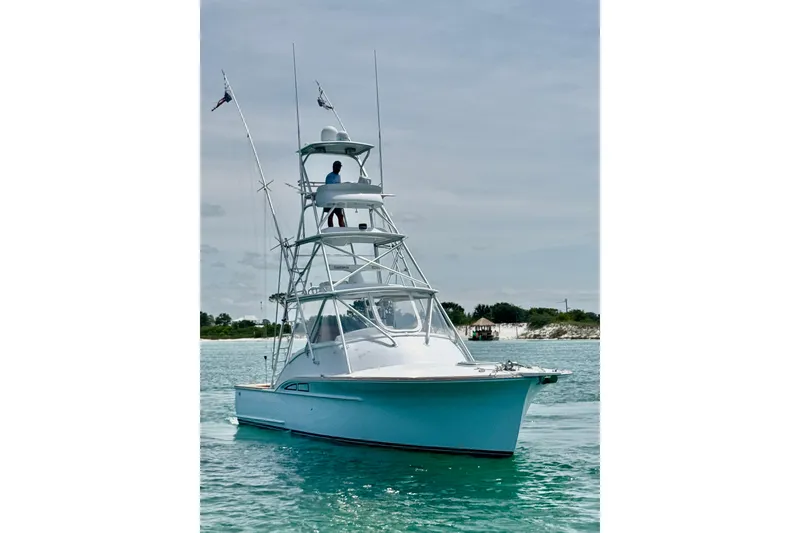 Slide: The Image of 2006 Miller Marine 36 boat on calm water with a person on the tower. - 3
