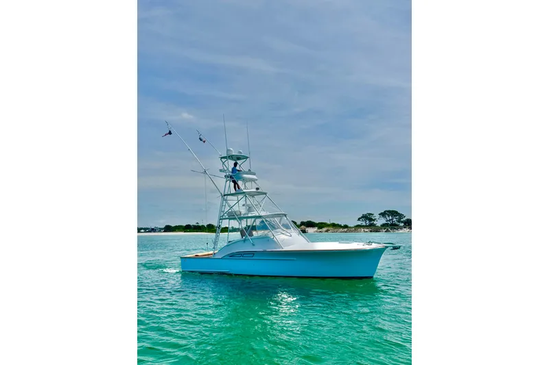 Slide: The Image of 2006 Miller Marine 36 boat on clear turquoise water under blue sky. - 4