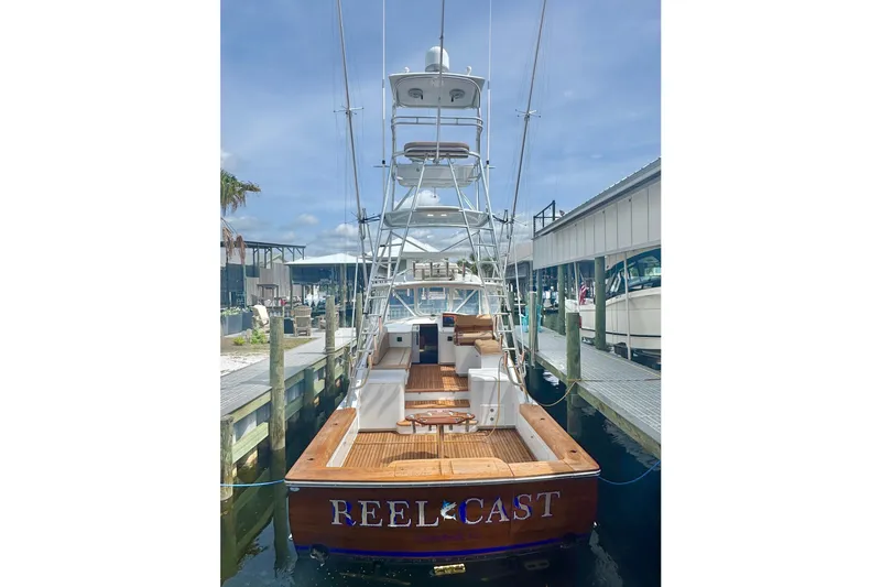 Slide: The Image of 2006 Miller Marine 36 boat named "Reel Cast" docked at a marina. - 8