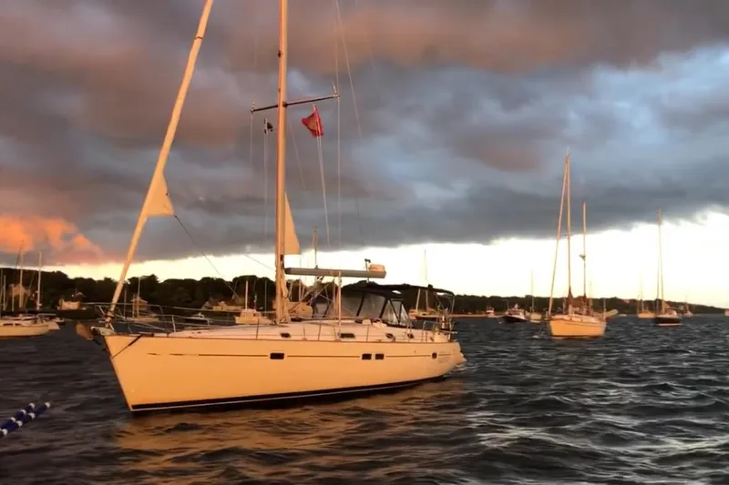 The Image of Sailboat Beneteau 411 (1998) on water at sunset with dramatic clouds. - 0