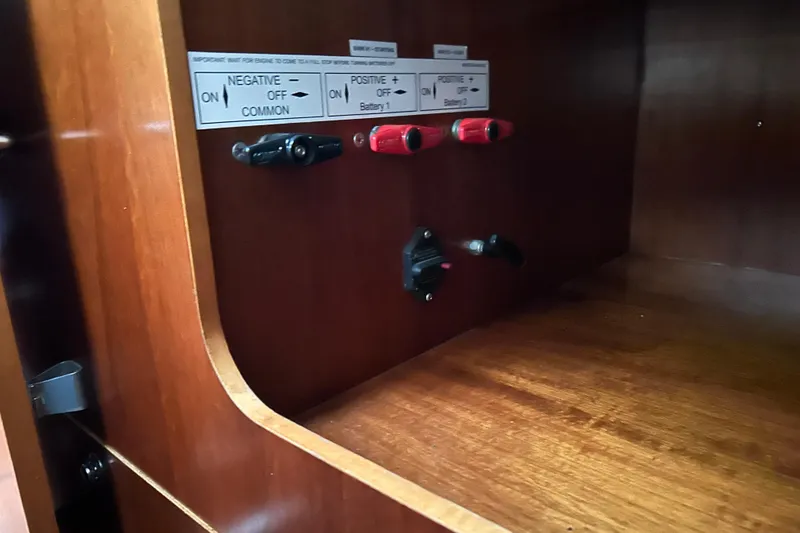 Slide: The Image of Electrical panel with switches inside a 1998 Beneteau 411 sailboat. - 13