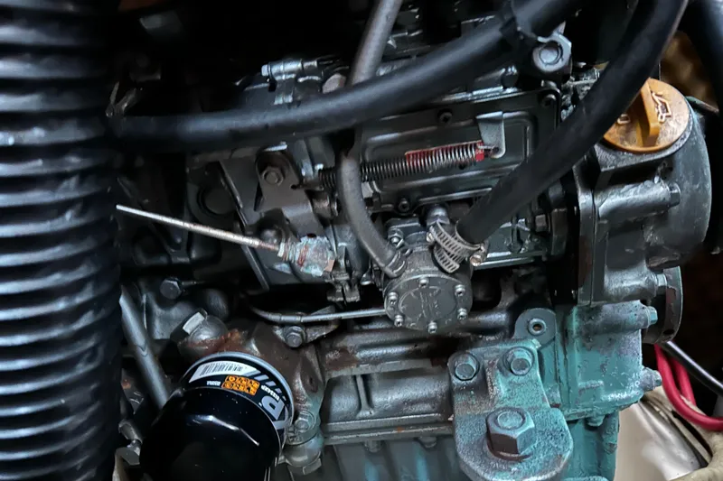 Slide: The Image of Engine components of a 1998 Beneteau 411 sailboat, showcasing intricate mechanical details. - 14