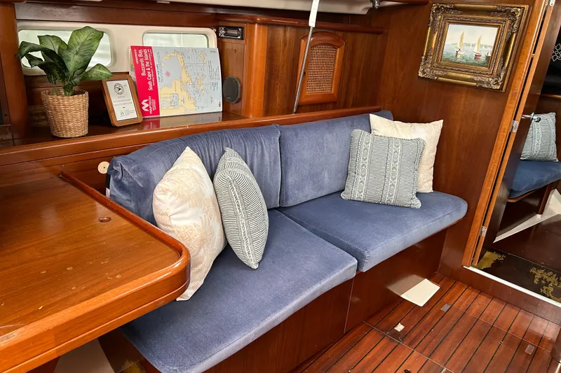Slide: The Image of Interior of a 1998 Beneteau 411 sailboat with cozy seating and nautical decor. - 4